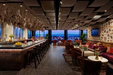 Modern rooftop bar and lounge with panoramic city views and sophisticated décor