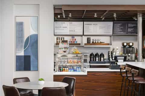 Modern hotel café with coffee bar and menu boards