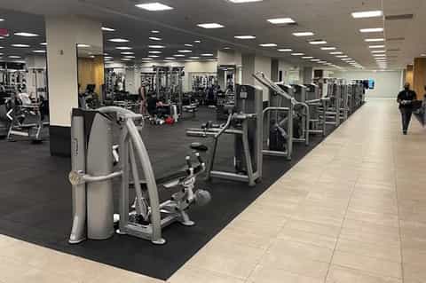 Large, modern fitness center with extensive cardio and weight training equipment throughout spacious floor