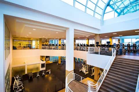 Modern multi-level fitness facility with gym equipment and skylights