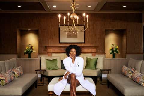 Spa relaxation room with symmetrical seating, warm lighting, and professional aesthetic