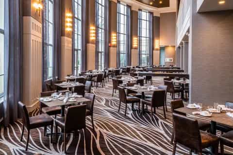 Fine dining restaurant with zebra-patterned carpet and tall windows