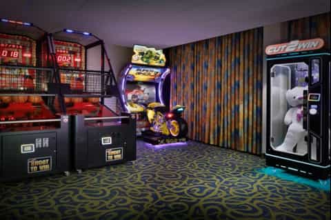 Game room with arcade machines, basketball game, and claw machine