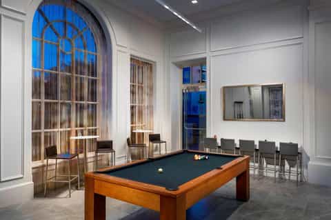 Recreation room with pool table, arched window, and contemporary seating area
