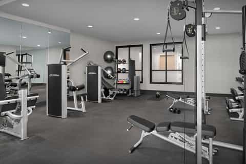 State-of-the-art fitness center with cardio machines and mirrored walls