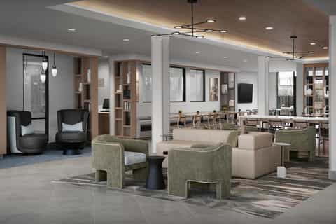 Modern hotel lobby lounge with contemporary seating, wood accents, and bright lighting