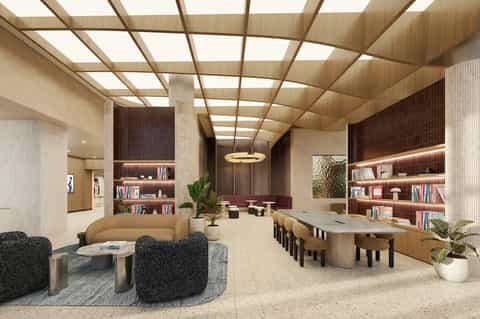 Contemporary lobby with curved seating, wooden ceiling, bookshelves, and modern furnishings