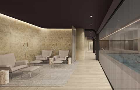 Luxury spa relaxation room with ambient lighting, beige seating, stone accents, and pool view