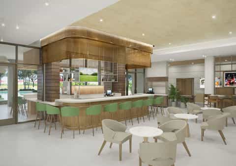 Modern hotel lobby and bar with wooden accent wall, green bar stools, beige seating areas, and indoor pool view