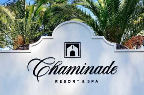 Chaminade Resort & Spa white entrance sign with palm trees and architectural details