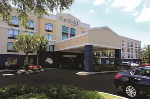 Fairfield by Marriott entrance with tan and dark exterior, porte-cochere, and landscaping