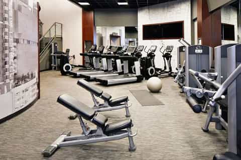 Well-equipped fitness center with treadmills, exercise bikes, and weight training equipment