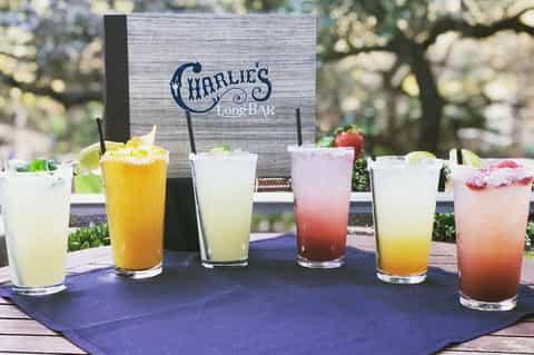 Charlie's Long Bar display of colorful cocktails with fruit garnishes