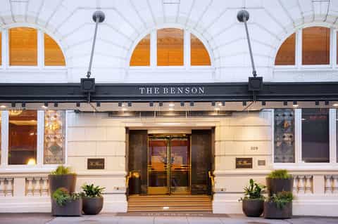 The Benson hotel storefront with arched windows, cream facade, and bronze doors