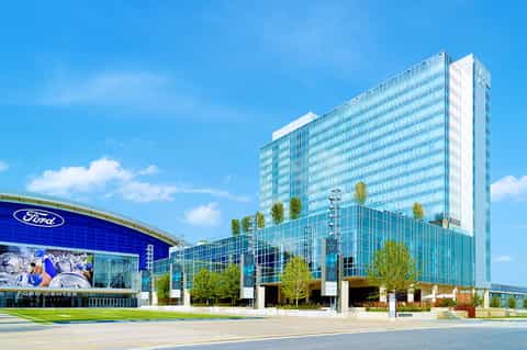 Modern Ford Center building with glass facade, blue signage, and landscaping