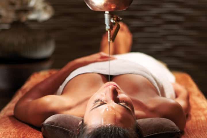 Facial treatment with heat lamp therapy in spa setting