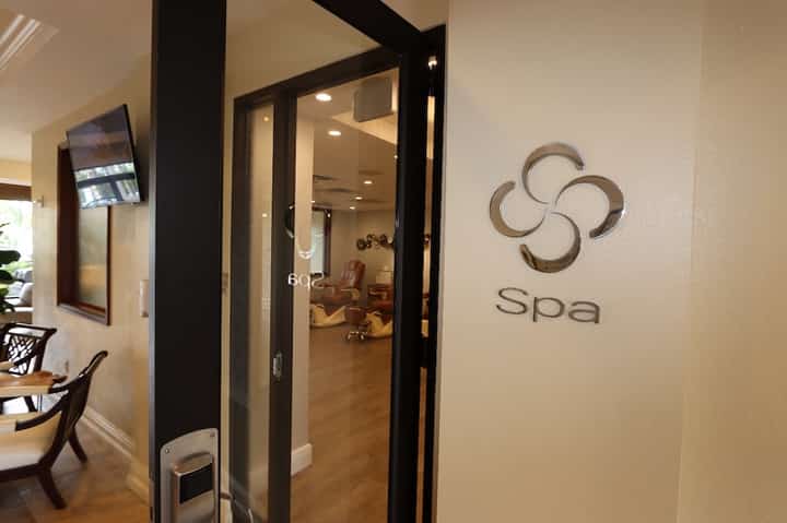 Spa entrance doorway with modern signage and interior seating visible