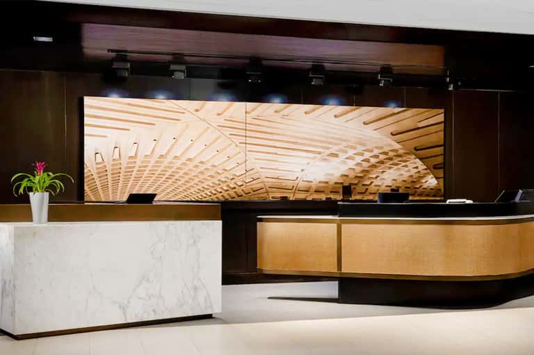 Sleek hotel reception desk with marble accents and wooden design elements