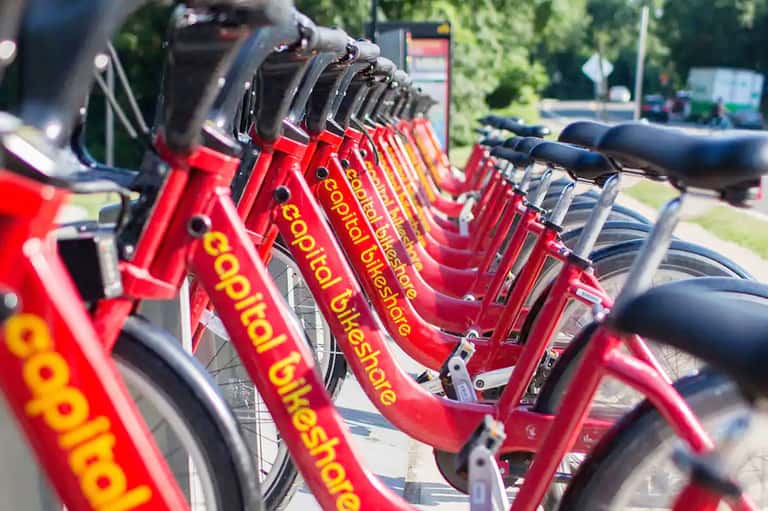 Row of red bike-share bicycles lined up at a docking station