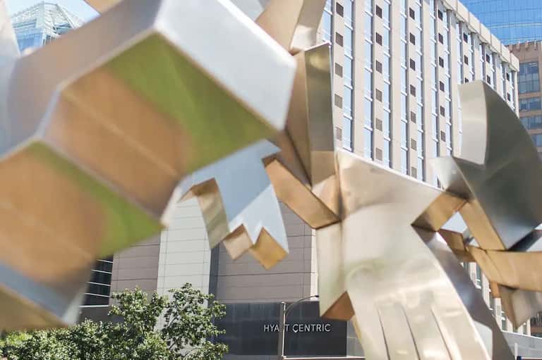 Hyatt Centric hotel exterior with modern architectural sculptural elements and tall residential buildings