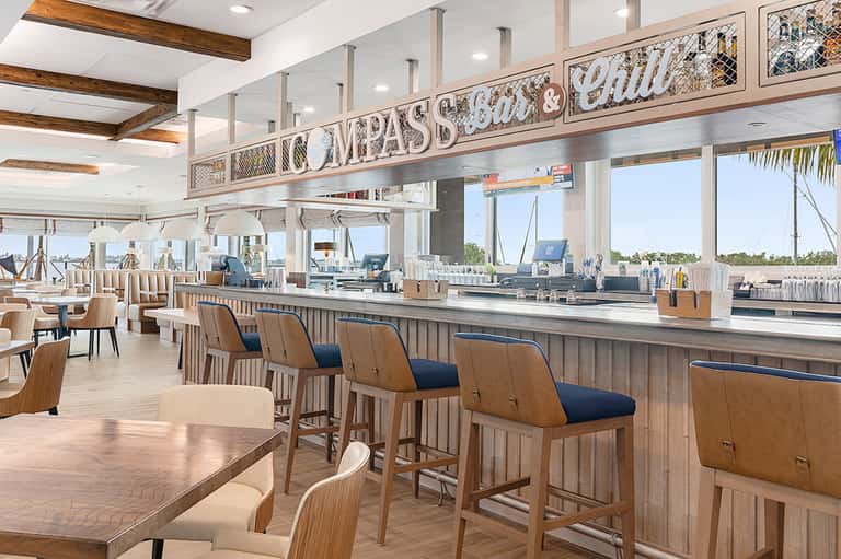 Upscale waterfront restaurant with wooden finishes and marina views