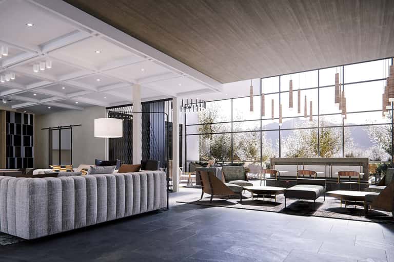 Modern lobby with curved gray sofa, floor-to-ceiling windows, and contemporary lighting fixtures