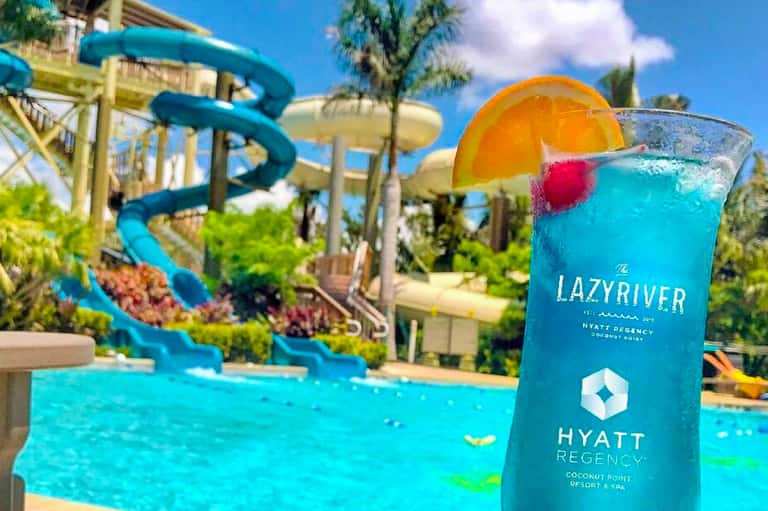 Blue cocktail with orange slice at Lazy River Hyatt Regency resort by water slides