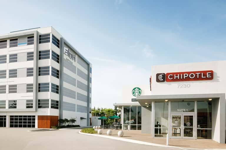 Contemporary office building with Chipotle and Starbucks storefronts on ground level