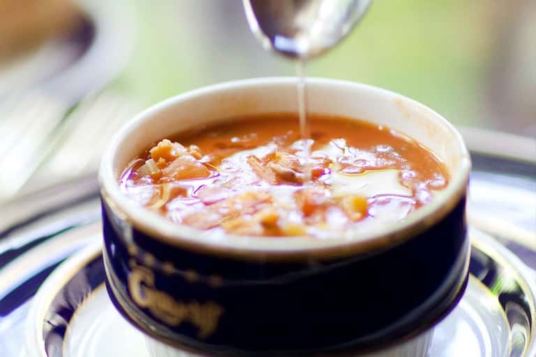 Luxury spa treatment with aromatic oil being drizzled into a bowl