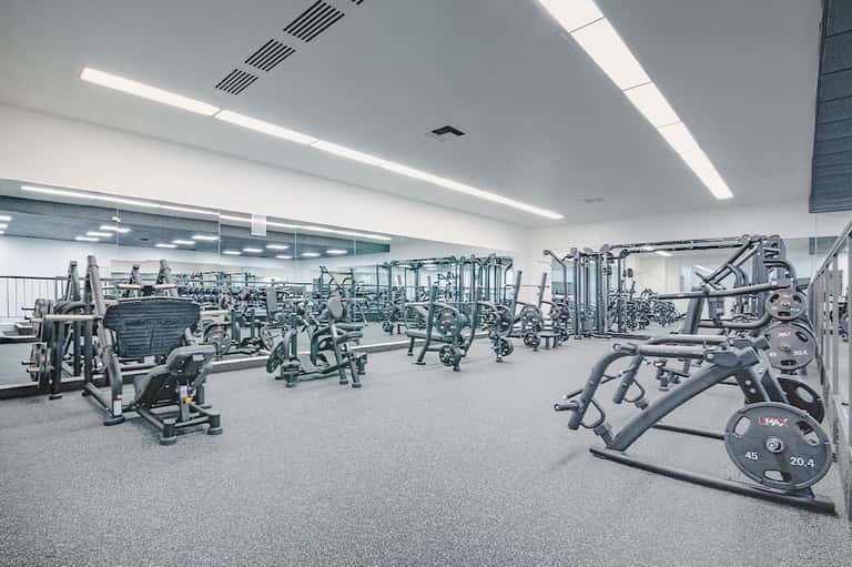 State-of-the-art fitness center with exercise equipment and mirrored walls