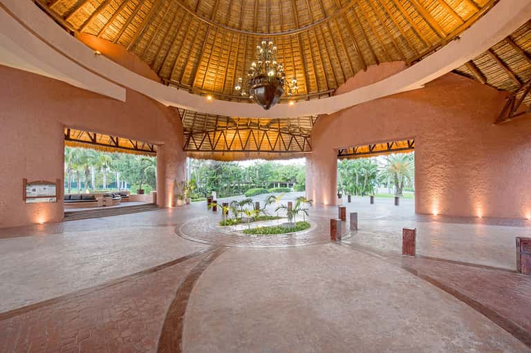 Spacious dome-shaped pavilion with terracotta walls and palm tree views