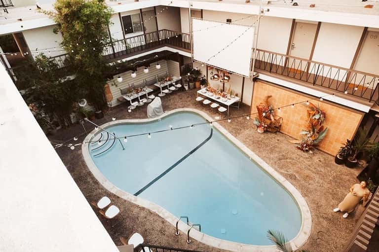 Aerial view of resort courtyard with kidney-shaped pool surrounded by lounge chairs