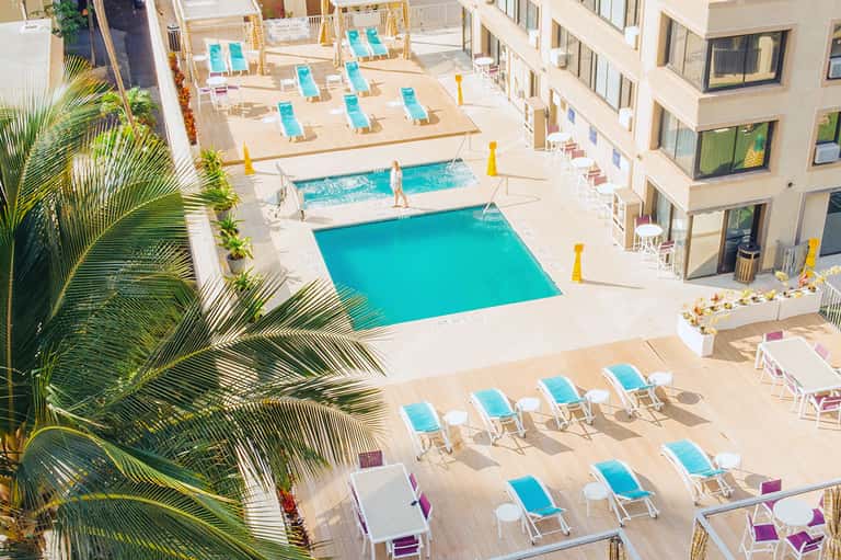 Aerial view of resort pool complex with turquoise pools and sun loungers