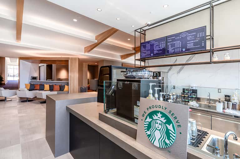 Contemporary Starbucks coffee shop interior with wooden beams and modern seating area