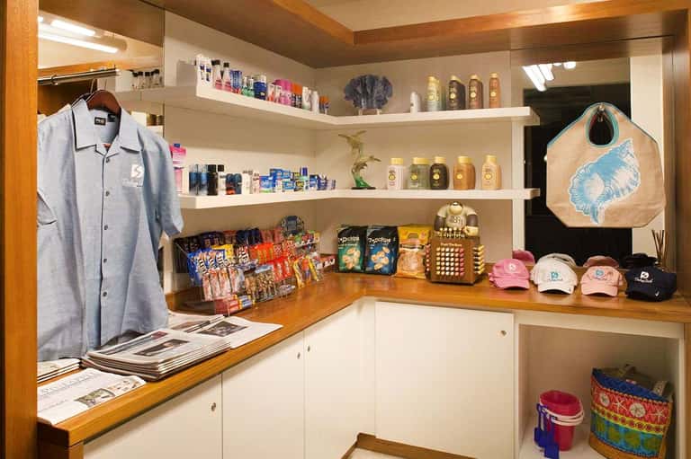 Resort gift shop interior with shelves of merchandise and branded apparel