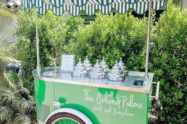 Green ice cream cart with striped awning at The Colony Palms Hotel and Bungalows