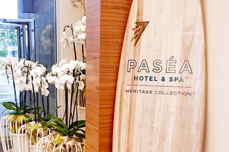 Pasea Hotel & Spa entrance with white orchid flowers and wooden signage
