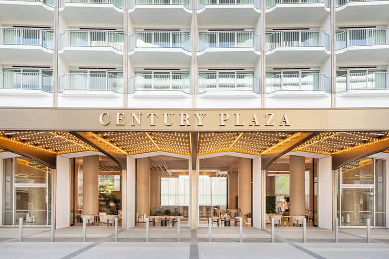 Century Plaza hotel entrance with illuminated awning and modern ground floor dining area