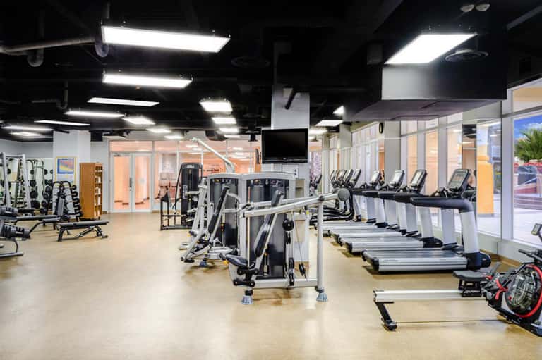 Modern fitness center with treadmills, exercise bikes, and strength training equipment