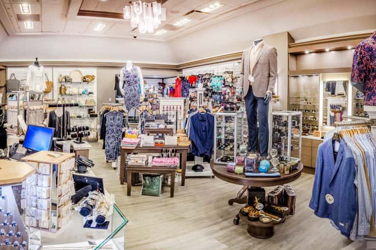 Upscale boutique interior with clothing displays, accessories, and modern retail fixtures