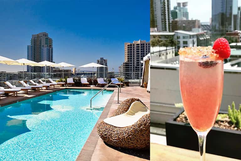 Rooftop pool with city skyline views and a coral cocktail with raspberry garnish
