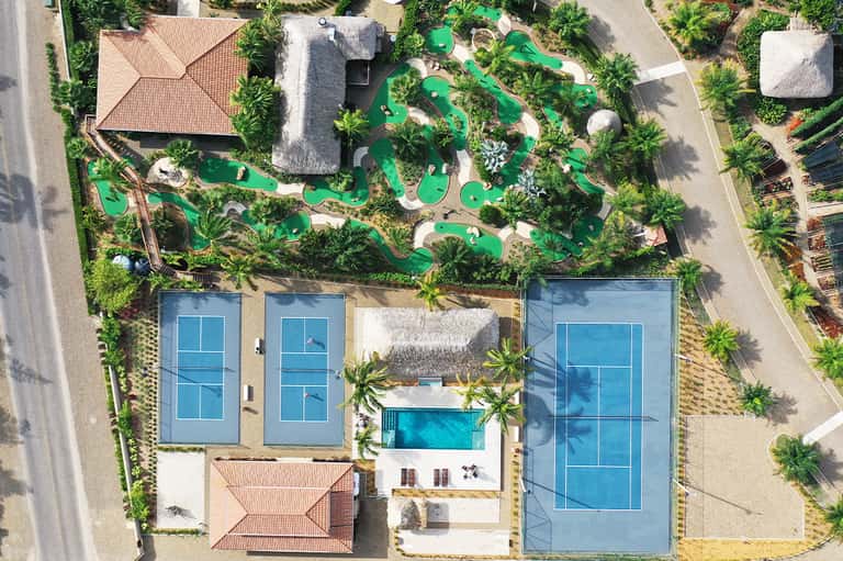 Aerial view of resort with pools, mini golf course, and manicured grounds