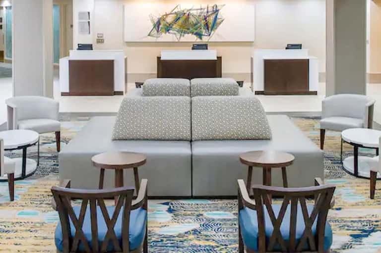 Modern hotel lobby with reception desks, contemporary seating, and colorful artwork