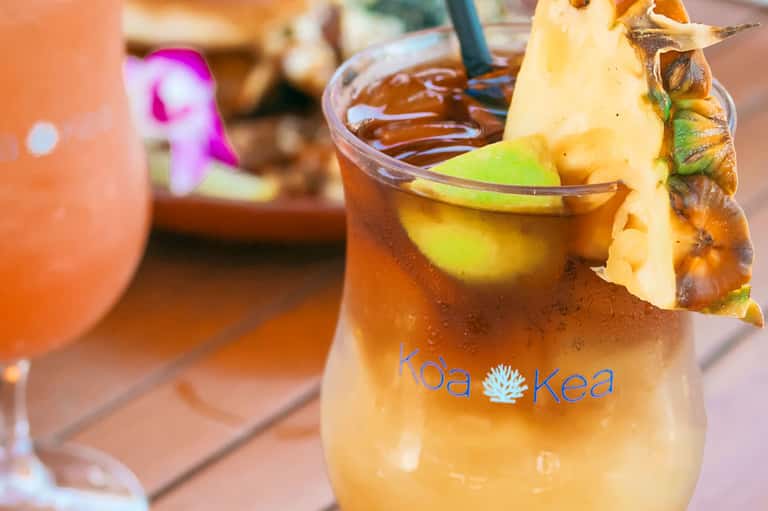 Tropical cocktail with pineapple garnish at a beachside resort bar