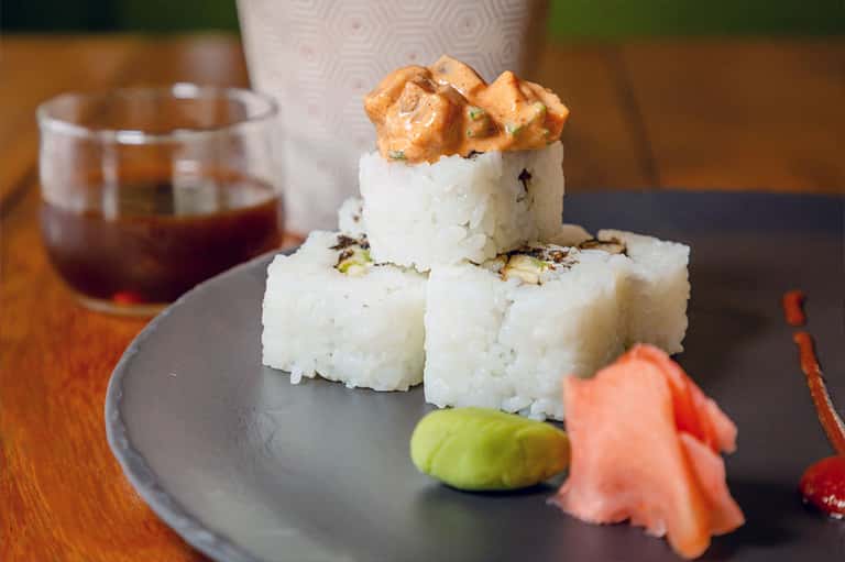 Plated dessert with white cake and nut topping