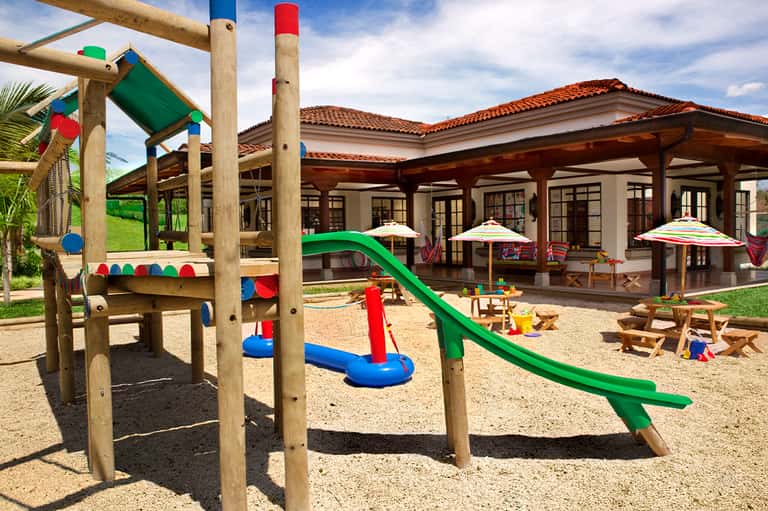 Colorful children's playground with slide and climbing structures near building