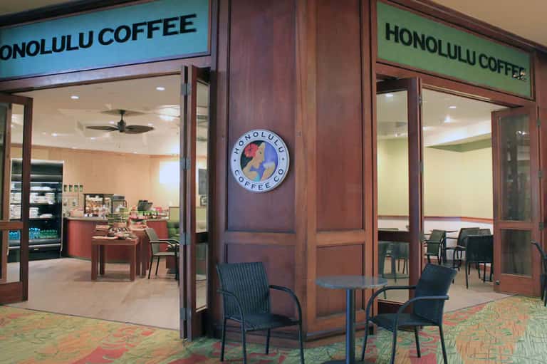 Honolulu Coffee shop interior with wooden entrance, seating area, and cafe counter