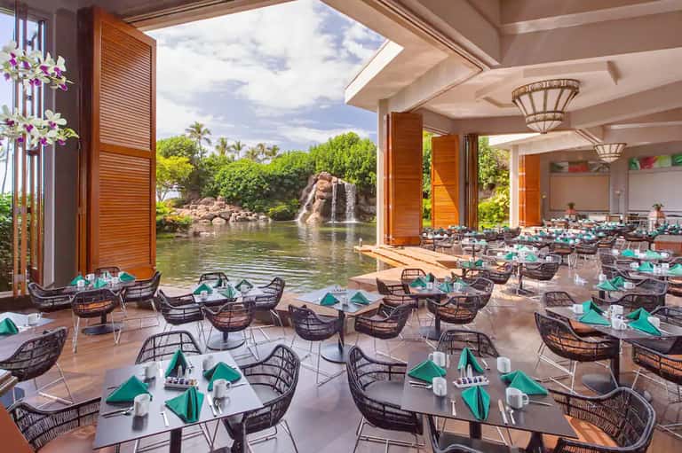 Fine dining restaurant overlooking a waterfall and tropical landscape with river views