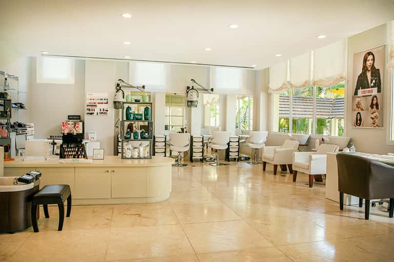 Bright spa and salon interior with treatment chairs, product displays, and comfortable seating