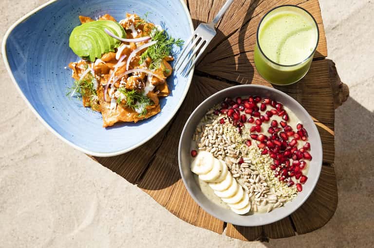 Healthy meal spread with fresh salad, smoothie, and yogurt bowl with berries